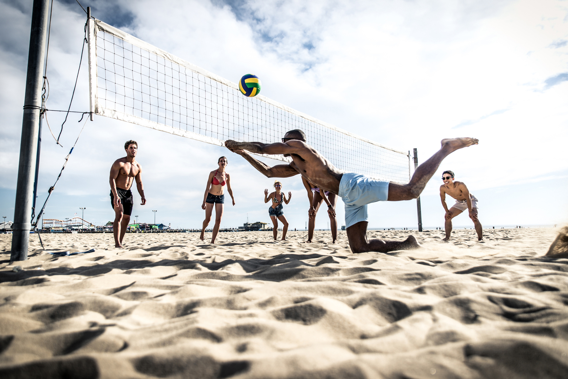 Group of Friends Playing Beach Volley on the Beach